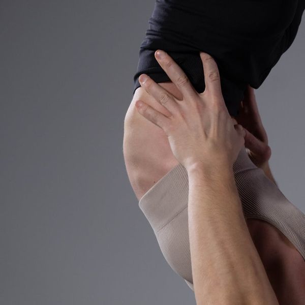 Man holding a difficult balance pose, showing core strength and focus.